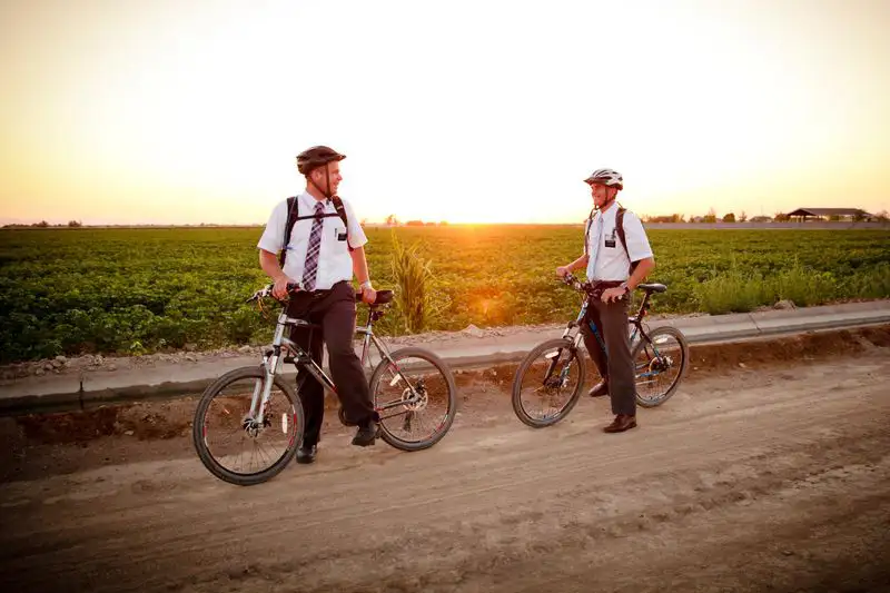 Missionaries riding bikes at sunset